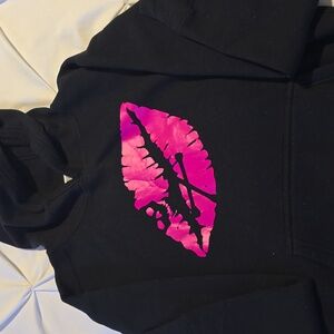 Lips with skull cross bones sweatshirt.